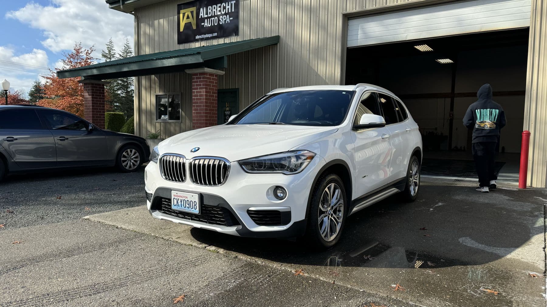 White BMW X1 after an exterior detail outside Albrecht Auto Spa in Ferndale, WA