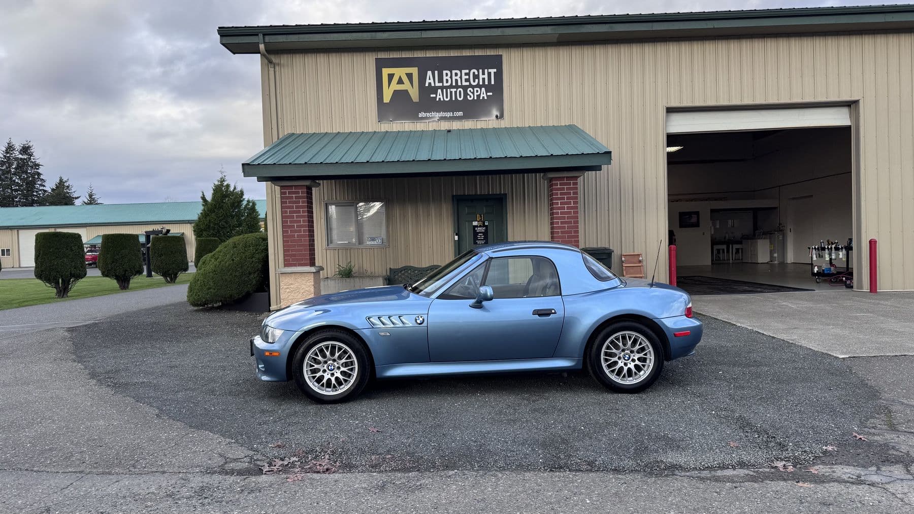 Light blue BMW Z3 roadster ceramic coated outside the bay doors at Albrecht Auto Spa in Ferndale, WA