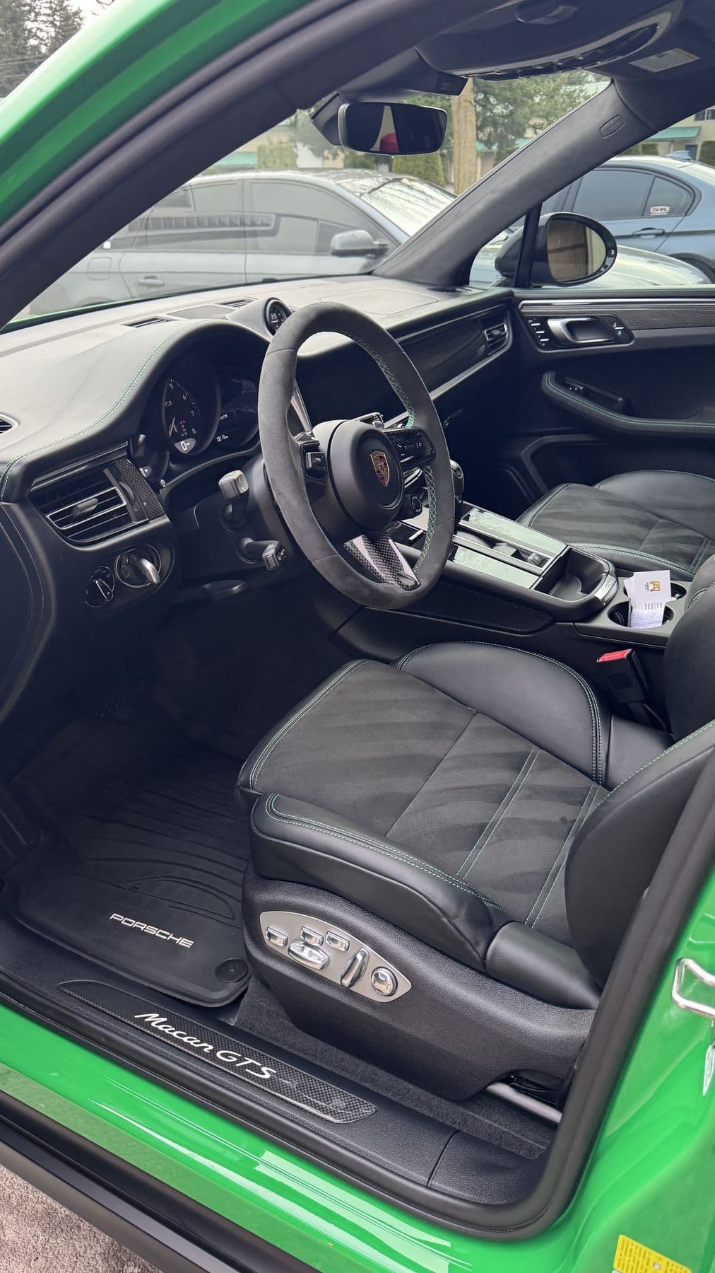 Green Porsche Macan GTS with the door open showing a freshly detailed cabin at Albrecht Auto Spa in Ferndale, WA