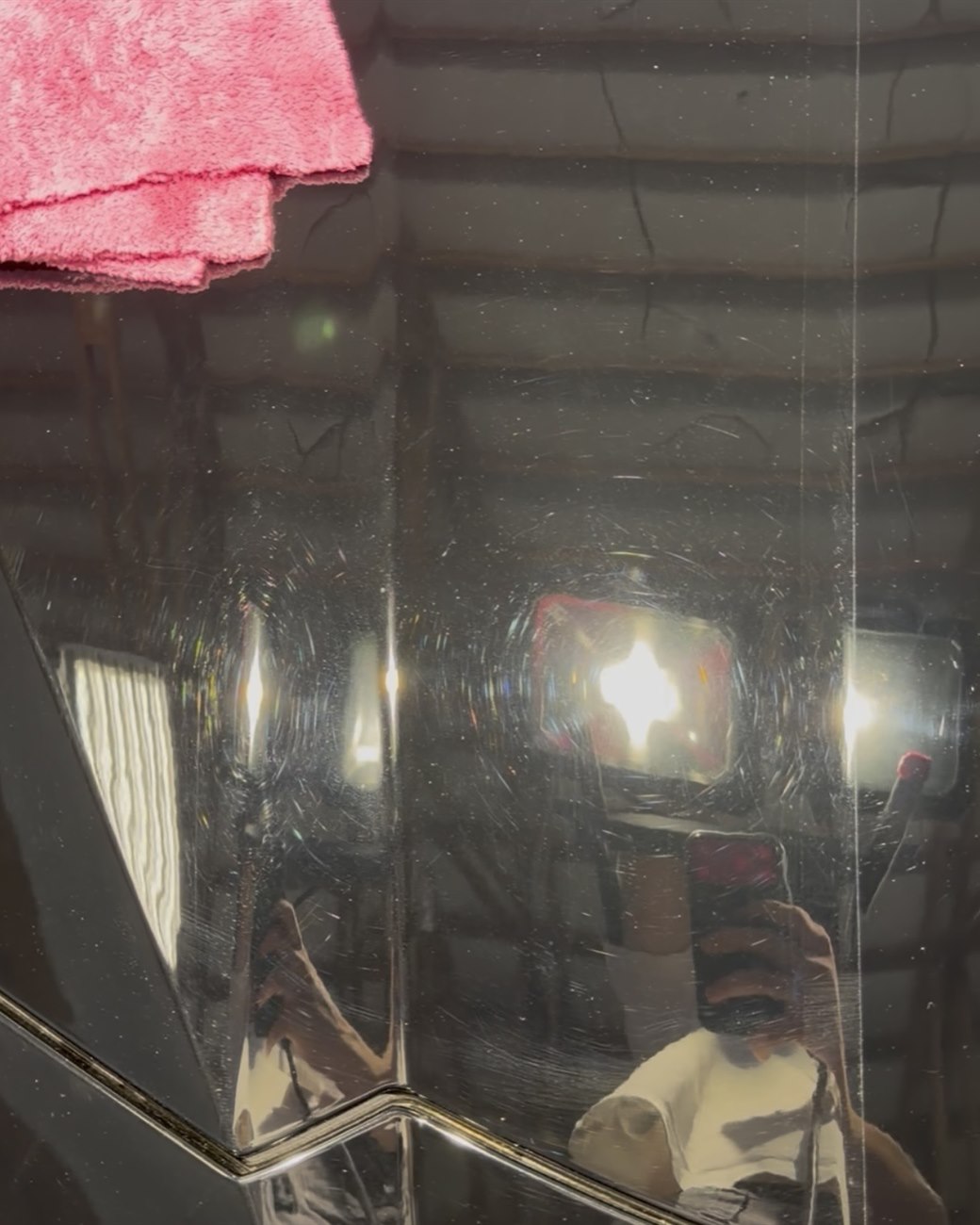 Paint before correction — swirl marks and holograms visible around the reflections